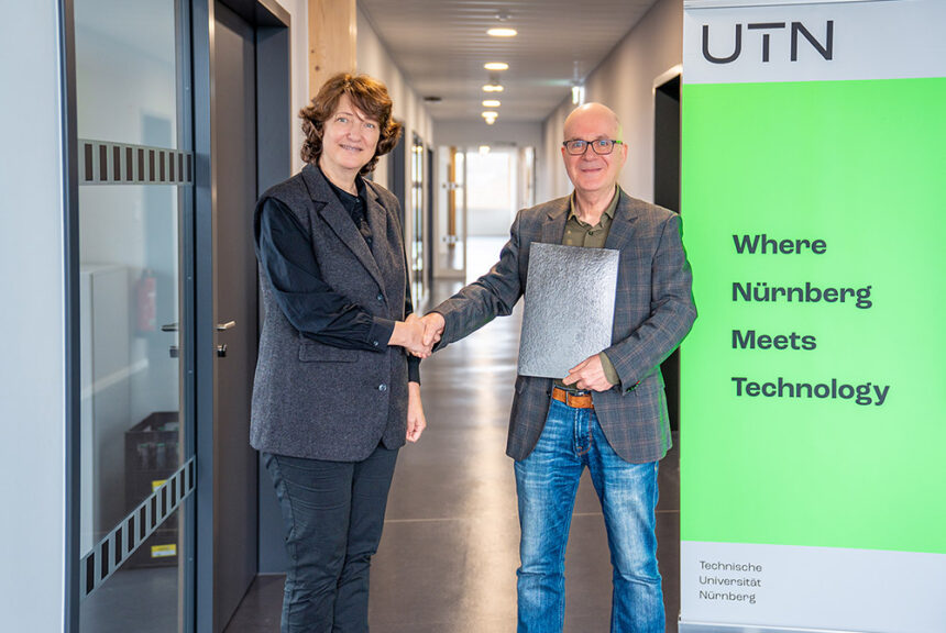 Herr Huth übergibt die Urkunde der neuen Professorin Daniela Jalobeanu
