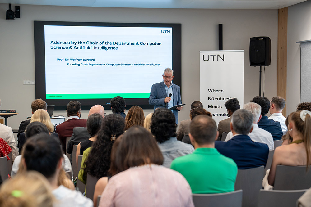 Prof. Dr. Wolfram Burgard is giving a speech on behalf of the Department of Computer Science & Artificial Intelligence.