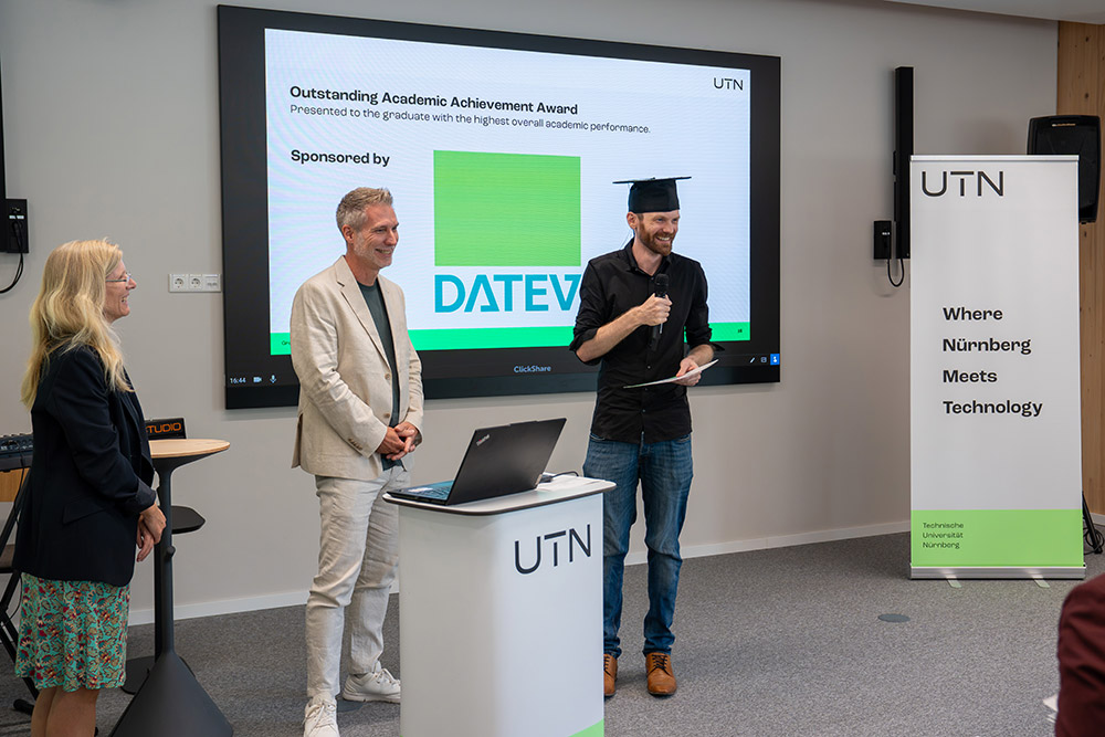 A graduate delivers an acceptance speech for the “Outstanding Academic Achievement Award,” sponsored by DATEV.